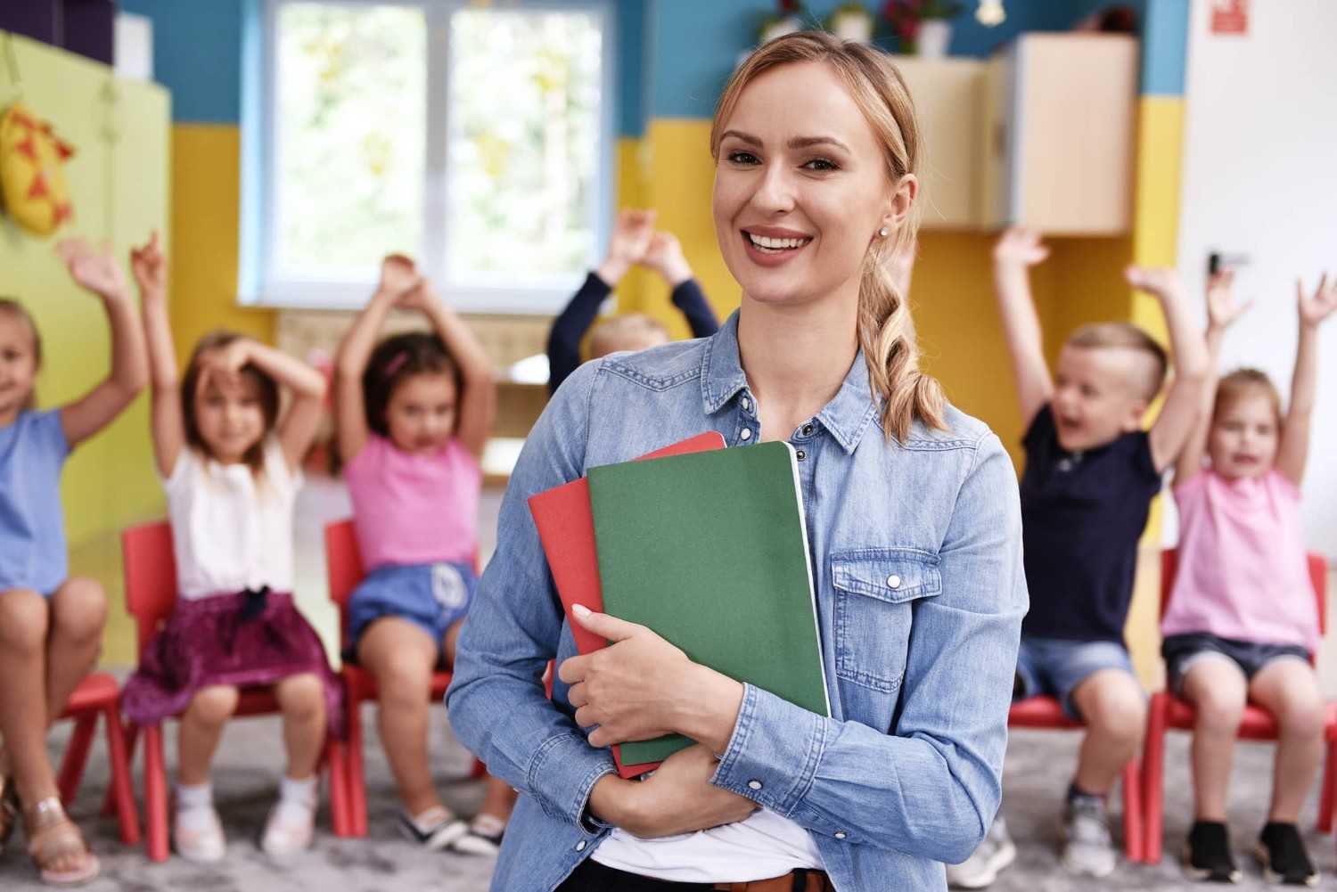 Childcare professional assisting children in a classroom